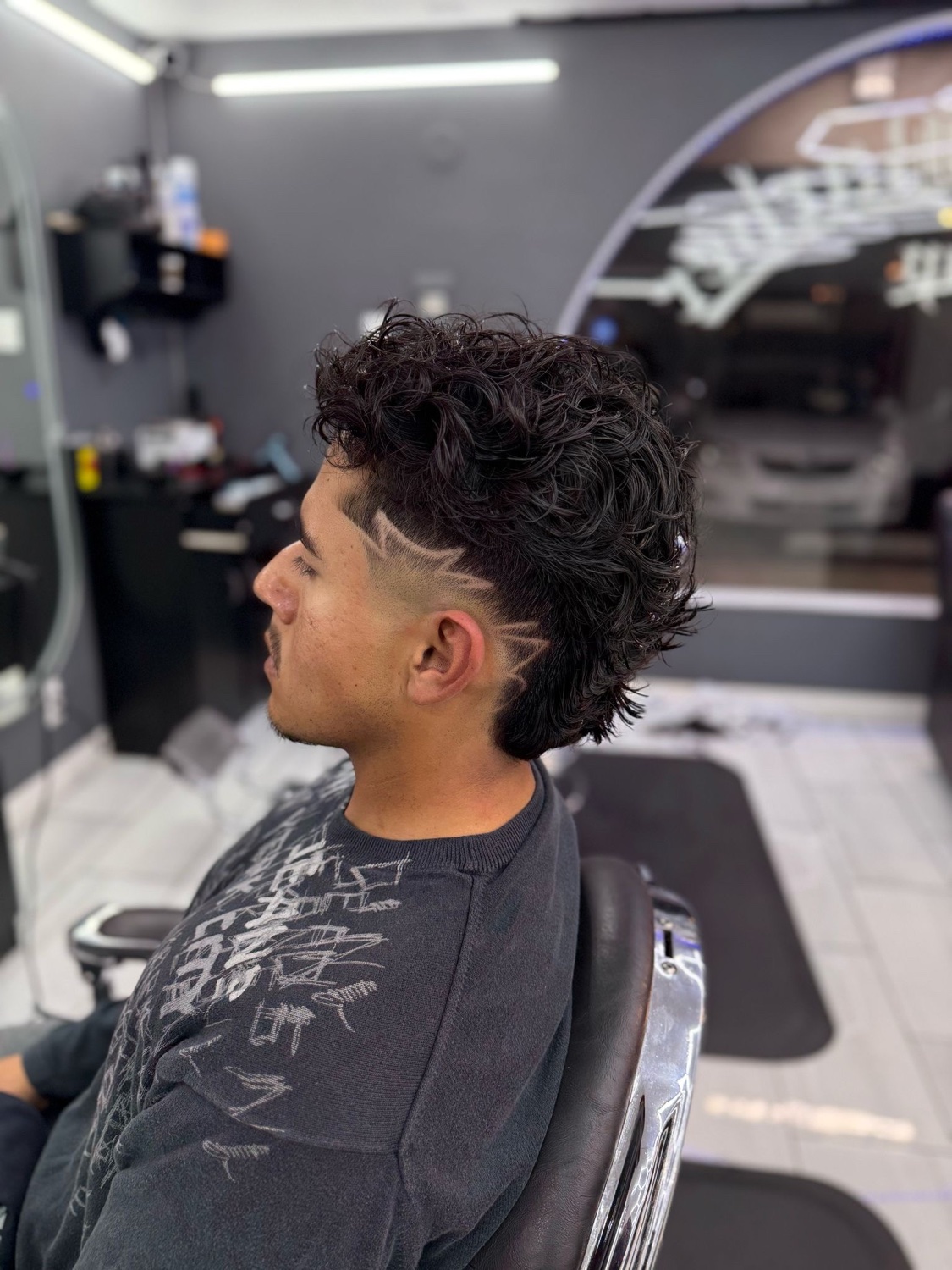 Curly top with razor design and fade