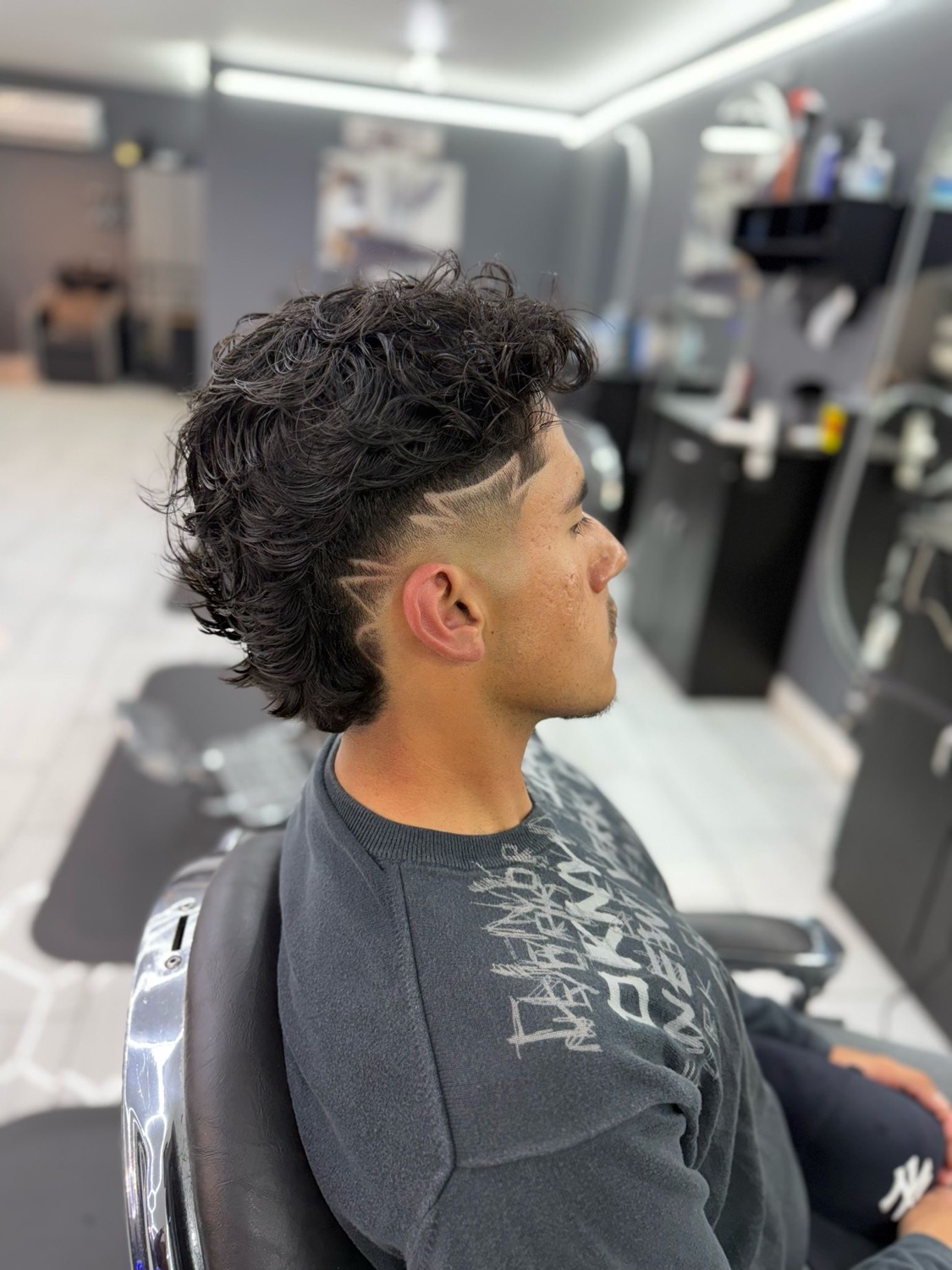 Curly top, razor design, sharp fade