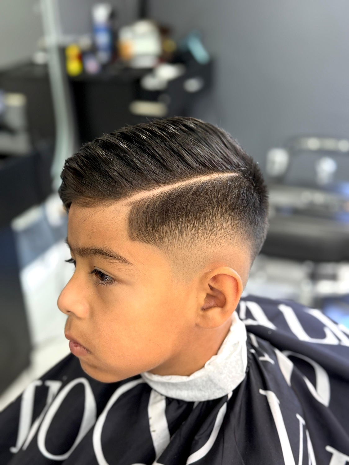 Kids side part with hard line and fade