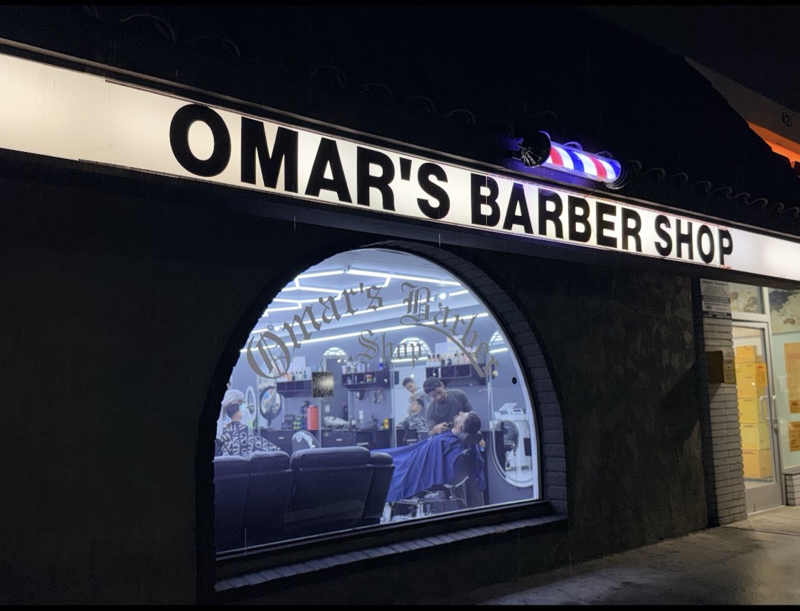 Omar's Barbershop storefront at night on Brookhurst St, Anaheim